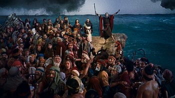 Movie still from “The Ten Commandments” (1956), directed by Cecil B. DeMille – A large group of people gathered on the beach; Extreme Wide shot, High angle