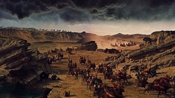 Movie still from “The Ten Commandments” (1956), directed by Cecil B. DeMille – A group of people on horses in the desert; Extreme Wide shot, High angle