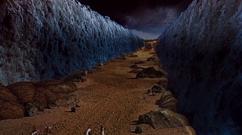 Movie still from “The Ten Commandments” (1956), directed by Cecil B. DeMille – An image of a scene of a valley with people walking on it; Extreme Wide shot, High angle
