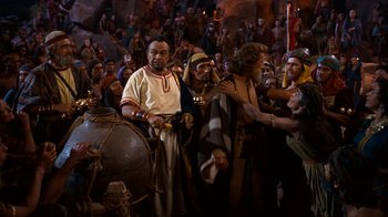 Movie still from “The Ten Commandments” (1956), directed by Cecil B. DeMille – A group of people standing next to each other in a room; Wide shot, High angle