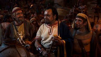 Movie still from “The Ten Commandments” (1956), directed by Cecil B. DeMille – A group of men in traditional clothing are gathered together; Medium shot, High angle