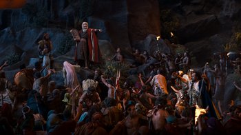 Movie still from “The Ten Commandments” (1956), directed by Cecil B. DeMille – A group of people gathered around a statue of a man; Extreme Wide shot, High angle