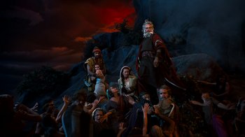 Movie still from “The Ten Commandments” (1956), directed by Cecil B. DeMille – A group of people gathered around a statue of a man; Wide shot, High angle