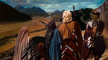 Movie still from “The Ten Commandments” (1956), directed by Cecil B. DeMille – A group of people standing on top of a hill; Extreme Wide shot, High angle