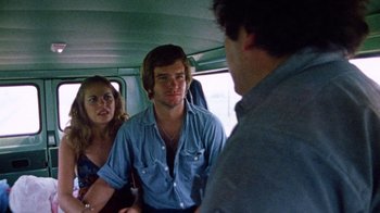 Movie still from “The Texas Chain Saw Massacre” (1974), directed by Tobe Hooper – A man and a woman are sitting in a bus; Medium shot, Over the shoulder angle