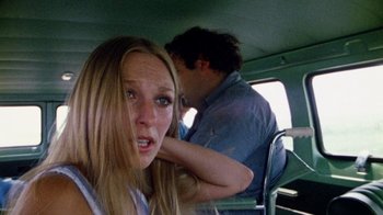 Movie still from “The Texas Chain Saw Massacre” (1974), directed by Tobe Hooper – A man and a woman in the back seat of a car; Close Up shot, Over the shoulder angle