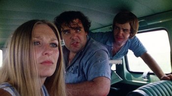 Movie still from “The Texas Chain Saw Massacre” (1974), directed by Tobe Hooper – A woman and two men in the back of a van; Close Up shot, Low angle