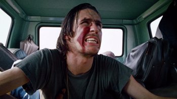 Movie still from “The Texas Chain Saw Massacre” (1974), directed by Tobe Hooper – A man with blood all over his face; Close Up shot, Low angle