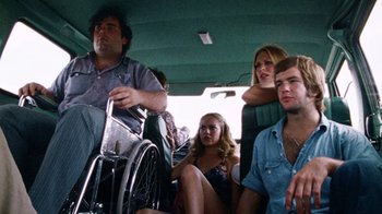 Movie still from “The Texas Chain Saw Massacre” (1974), directed by Tobe Hooper – A group of people sitting in the back of a van; Medium shot, Low angle