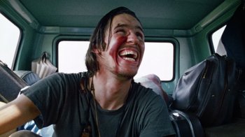 Movie still from “The Texas Chain Saw Massacre” (1974), directed by Tobe Hooper – A young man with blood all over his face; Close Up shot, Low angle