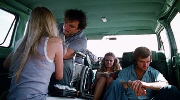 Movie still from “The Texas Chain Saw Massacre” (1974), directed by Tobe Hooper – A group of people sitting in a car; Medium shot, Low angle