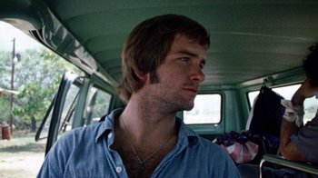 Movie still from “The Texas Chain Saw Massacre” (1974), directed by Tobe Hooper – A man with a beard is sitting in a van; Close Up shot, Low angle