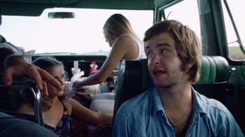 Movie still from “The Texas Chain Saw Massacre” (1974), directed by Tobe Hooper – A man and a woman sitting in the back of a car; Close Up shot, Over the shoulder angle