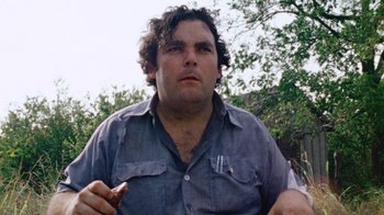 Movie still from “The Texas Chain Saw Massacre” (1974), directed by Tobe Hooper – A person holding food in his hand; Close Up shot, Low angle