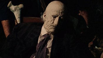 Movie still from “The Texas Chain Saw Massacre” (1974), directed by Tobe Hooper – An old man in a suit and a tie; Close Up shot, High angle