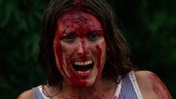 Movie still from “The Texas Chain Saw Massacre” (1974), directed by Tobe Hooper – A person with blood on her face; Close Up shot, High angle