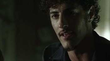 Movie still from “The Texas Chainsaw Massacre” (2003), directed by Marcus Nispel – A person wearing a black shirt; Close Up shot, Over the shoulder angle