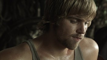 Movie still from “The Texas Chainsaw Massacre” (2003), directed by Marcus Nispel – A person wearing a tank top; Close Up shot, Over the shoulder angle