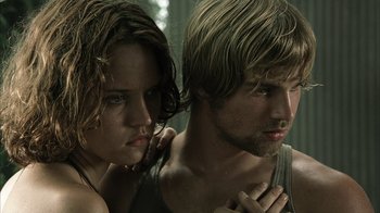 Movie still from “The Texas Chainsaw Massacre” (2003), directed by Marcus Nispel – A man and a woman standing next to each other; Close Up shot, Low angle