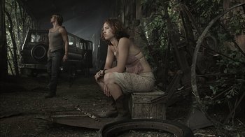 Movie still from “The Texas Chainsaw Massacre” (2003), directed by Marcus Nispel – A woman sitting on top of a wooden bench; Medium shot, Low angle