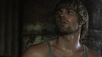 Movie still from “The Texas Chainsaw Massacre” (2003), directed by Marcus Nispel – A person wearing a tank top; Close Up shot, Low angle