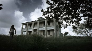 Movie still from “The Texas Chainsaw Massacre” (2003), directed by Marcus Nispel – An old abandoned building sitting on top of a hill; Extreme Wide shot, Low angle