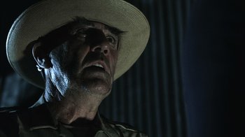 Movie still from “The Texas Chainsaw Massacre” (2003), directed by Marcus Nispel – A person wearing a straw hat; Close Up shot, Low angle