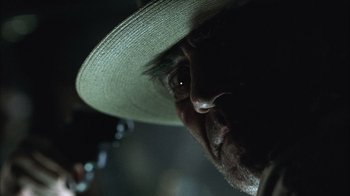 Movie still from “The Texas Chainsaw Massacre” (2003), directed by Marcus Nispel – A person wearing a hat; Extreme Close Up shot, Low angle