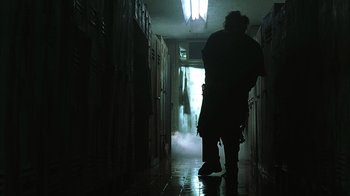 Movie still from “The Texas Chainsaw Massacre” (2003), directed by Marcus Nispel – Two people are walking in a dark hallway; Wide shot, Low angle