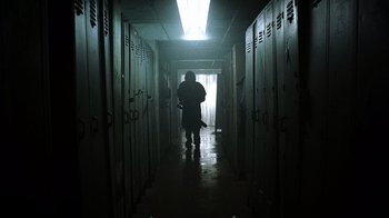 Movie still from “The Texas Chainsaw Massacre” (2003), directed by Marcus Nispel – A person walking through a hallway of lockers; Wide shot, Low angle