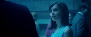 Movie still from “The Theory of Everything” (2014), directed by James Marsh – A young woman looking into a mirror in a blue room; Close Up shot, Over the shoulder angle