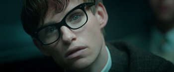 Movie still from “The Theory of Everything” (2014), directed by James Marsh – A person wearing glasses; Close Up shot, Low angle
