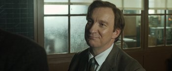 Movie still from “The Theory of Everything” (2014), directed by James Marsh – A person wearing a suit and tie; Close Up shot, Low angle