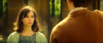 Movie still from “The Theory of Everything” (2014), directed by James Marsh – A woman standing in front of a man in front of a window; Close Up shot, Over the shoulder angle