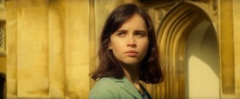 Movie still from “The Theory of Everything” (2014), directed by James Marsh – A young woman with long brown hair stares into the camera; Close Up shot, High angle