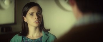 Movie still from “The Theory of Everything” (2014), directed by James Marsh – A woman looking into a mirror while standing up; Close Up shot, Over the shoulder angle