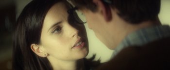 Movie still from “The Theory of Everything” (2014), directed by James Marsh – A woman looking at a man in a mirror; Close Up shot, Over the shoulder angle