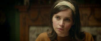 Movie still from “The Theory of Everything” (2014), directed by James Marsh – A person wearing a headband; Close Up shot, Over the shoulder angle