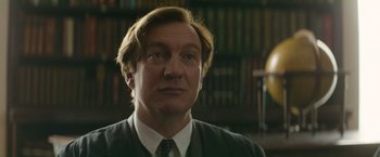 Movie still from “The Theory of Everything” (2014), directed by James Marsh – A person wearing a suit and tie; Close Up shot, Low angle