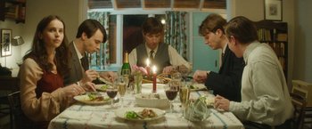 Movie still from “The Theory of Everything” (2014), directed by James Marsh – A group of people sitting around a dinner table; Medium shot, High angle
