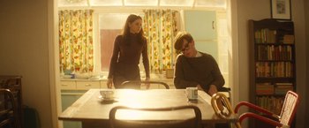 Movie still from “The Theory of Everything” (2014), directed by James Marsh – Two people sitting at a table in a room; Medium shot, Over the shoulder angle