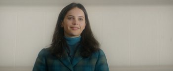 Movie still from “The Theory of Everything” (2014), directed by James Marsh – A young woman in a blue plaid jacket; Close Up shot, Low angle