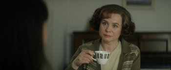 Movie still from “The Theory of Everything” (2014), directed by James Marsh – A woman holding a coffee cup while sitting in a chair; Close Up shot, Over the shoulder angle