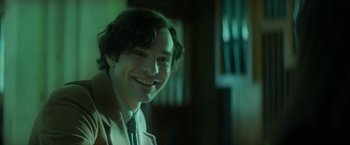 Movie still from “The Theory of Everything” (2014), directed by James Marsh – A person wearing a suit and tie; Close Up shot, Over the shoulder angle