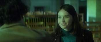 Movie still from “The Theory of Everything” (2014), directed by James Marsh – A person smiling at the camera; Close Up shot, Over the shoulder angle