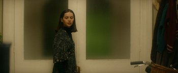 Movie still from “The Theory of Everything” (2014), directed by James Marsh – A woman standing in front of a green wall; Medium shot, Over the shoulder angle