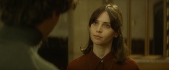 Movie still from “The Theory of Everything” (2014), directed by James Marsh – A woman in a red shirt looking at a man in a brown shirt; Close Up shot, Over the shoulder angle