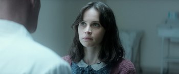 Movie still from “The Theory of Everything” (2014), directed by James Marsh – A person with long dark hair; Close Up shot, Over the shoulder angle