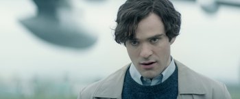 Movie still from “The Theory of Everything” (2014), directed by James Marsh – A person wearing a jacket and a tie; Close Up shot, Over the shoulder angle