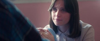 Movie still from “The Theory of Everything” (2014), directed by James Marsh – A person holding something in her hand; Close Up shot, Over the shoulder angle
